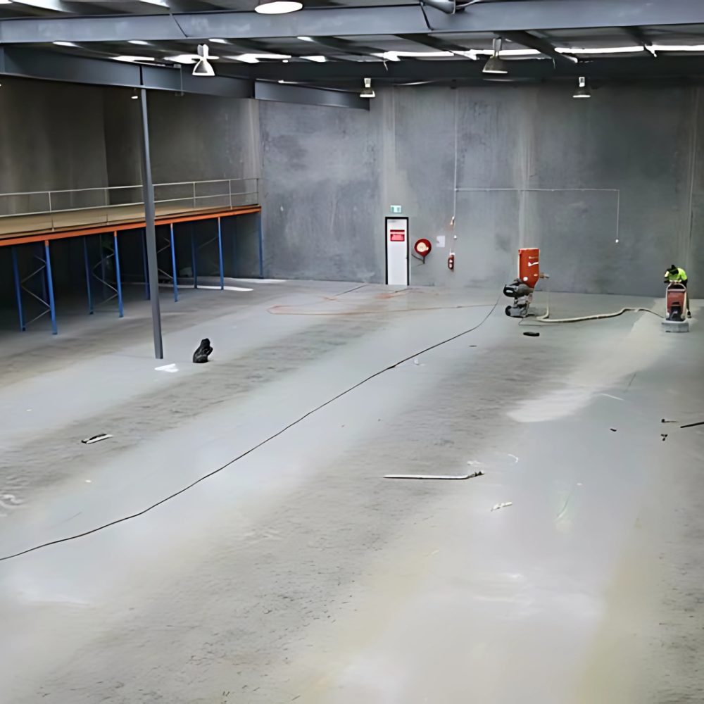 Bare warehouse concrete before Apex industrial epoxy install