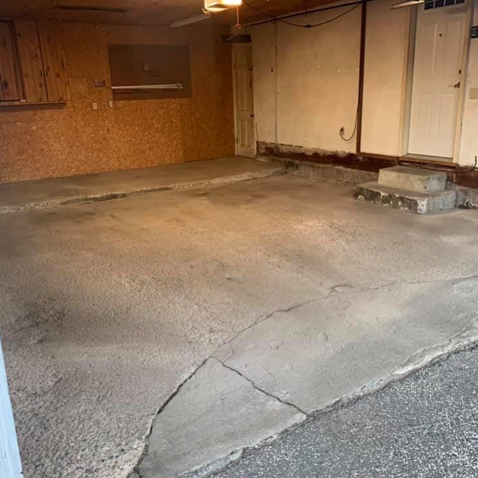 Cracked bare garage concrete before Apex epoxy coating