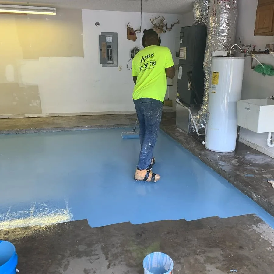Apex crew rolling epoxy basecoat during garage floor install in St. Petersburg, FL