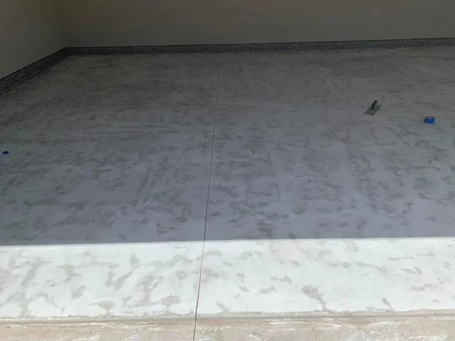 Prepped concrete slab with dark flake perimeter before Apex install in Atlanta, GA