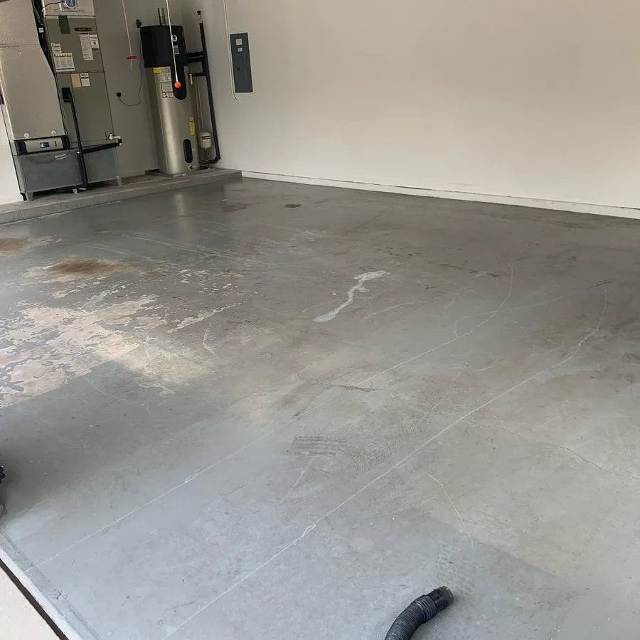 Stained bare concrete garage slab before Apex epoxy install in Fort Myers, FL