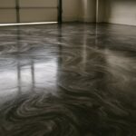 Metallic epoxy garage floor with a swirling charcoal, pewter and silver pattern
