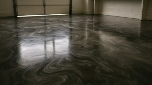 Metallic epoxy garage floor with a swirling charcoal, pewter and silver pattern